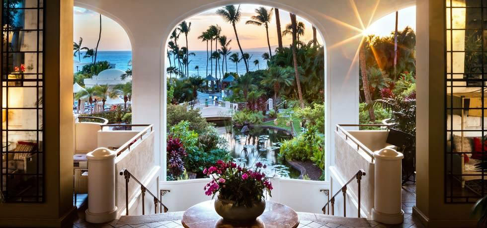 Fairmont Kea Lani presents Queen sofa beds, stone walk­-in showers, and private balconies with table and chairs.